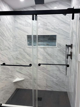 Marble tile shower enclosure by Shapiro Bathrooms the best bathroom remodel contractor in Salem NH