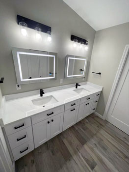 Modernized bathroom with white marble lavatory top and LED lighting around the mirrors makes this bathroom makeover shine in Portsmouth NH. Bath remodeling expert Shapiro Bathrooms & More brought their expertise in bath design and construction to make this bath renovation a success.