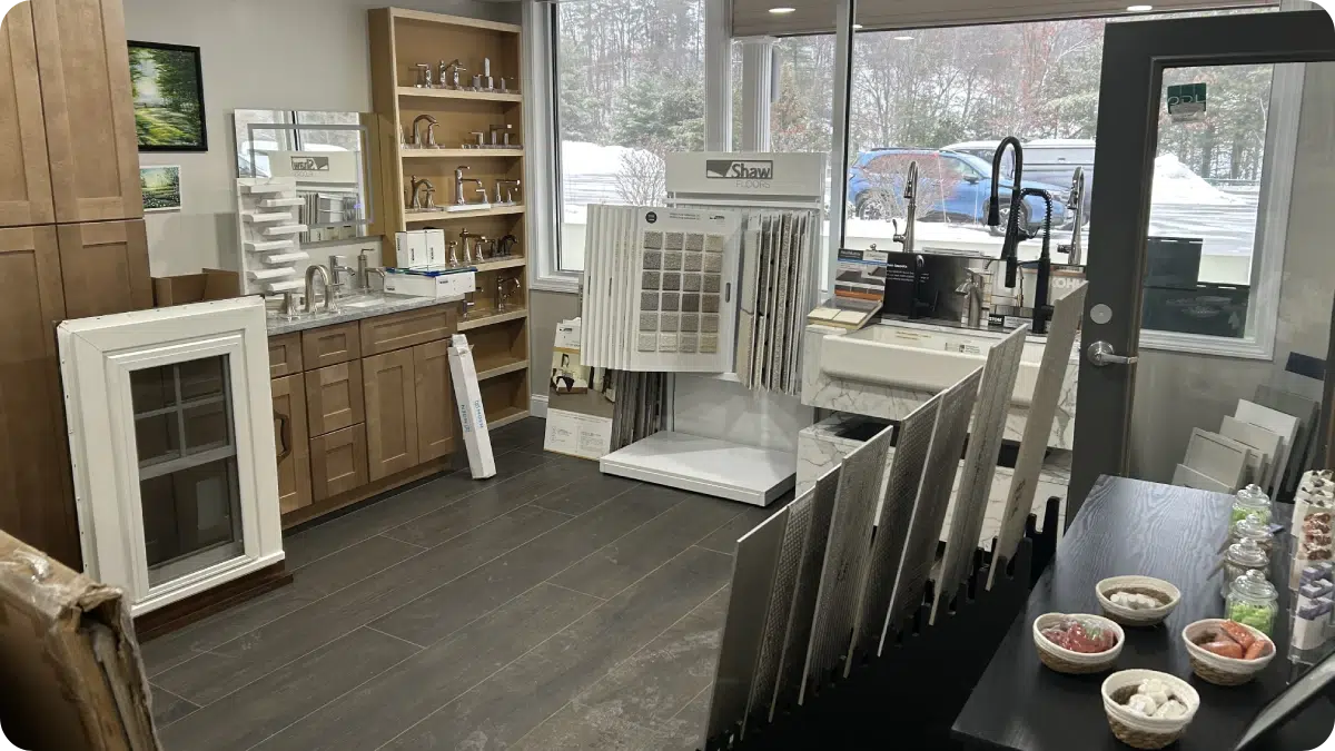 Inside the Shapiro Bathrooms & More New Hampshire showroom featuring displays of custom vanities, hardware, flooring tile samples, and fixtures.
