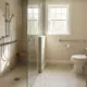 Modern aging-in-place bathroom remodel in New Hampshire. This comfortable, modern retreat features a custom walk-in shower with a glass enclosure, built-in shower bench, and an adjustable hand-shower system. For added safety without sacrificing style, it includes properly blocked, permanently installed grab bars rather than unreliable suction cups.