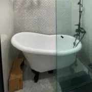 Tub-in-shower wetroom, also known as a shub. Features a freestanding bathtub inside of an open shower.