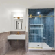 Small bathroom layout with a floating white sink, gold fixtures, gray tile wainscot and a navy vertical-tile walk-in shower, an idea for NH homes.